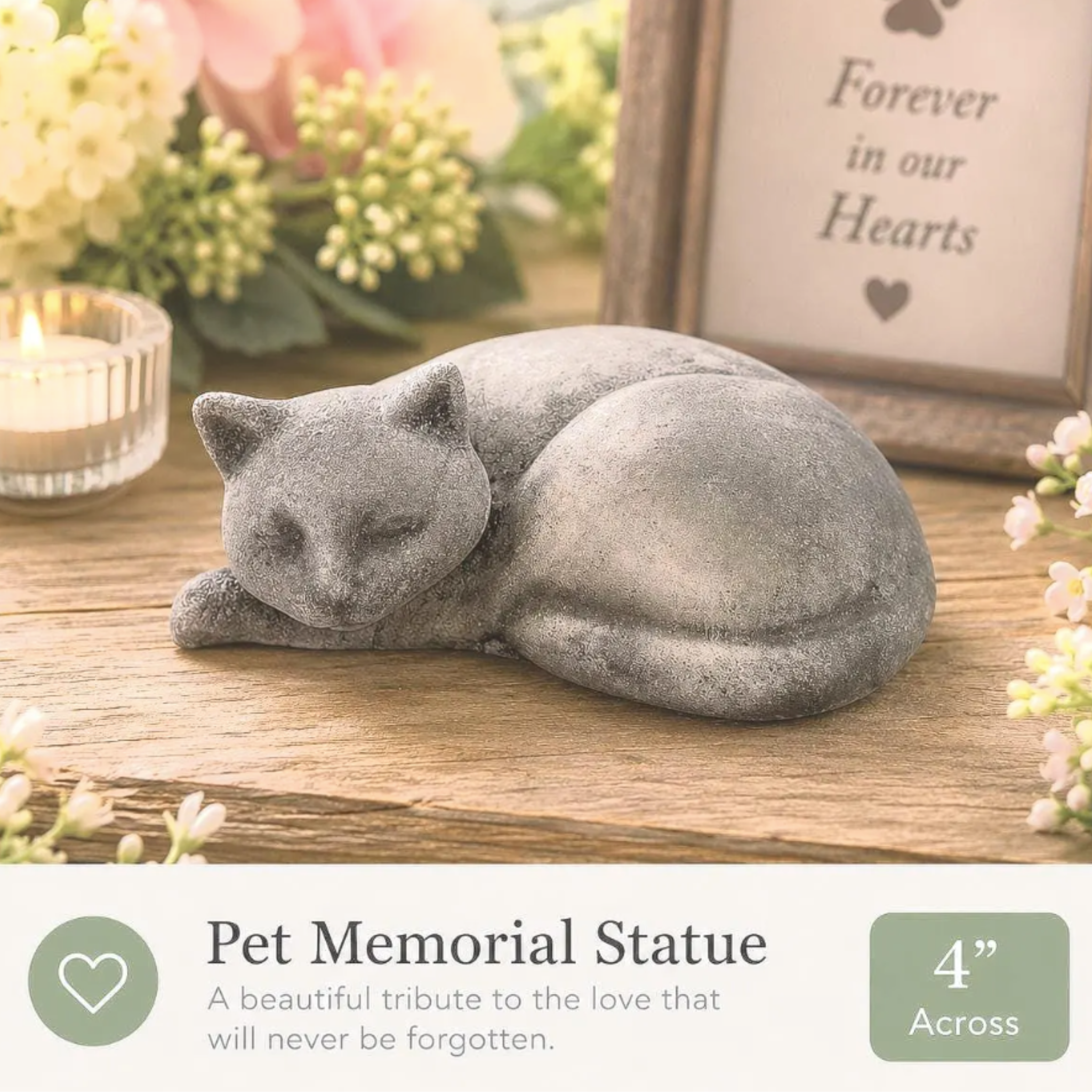 Pet Memorial Statue of a cat on a wooden surface with flowers and a frame in the background.