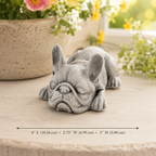 Decorative French bulldog figurine on a surface with flowers in the background. Text shows 4 inches in length. 