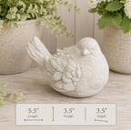 Detailed natural concrete dove sculpture with dimensions displayed on a wooden surface with plants in the background.