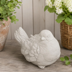 Detailed natural concrete dove sculpture with dimensions displayed on a wooden surface with plants in the background.